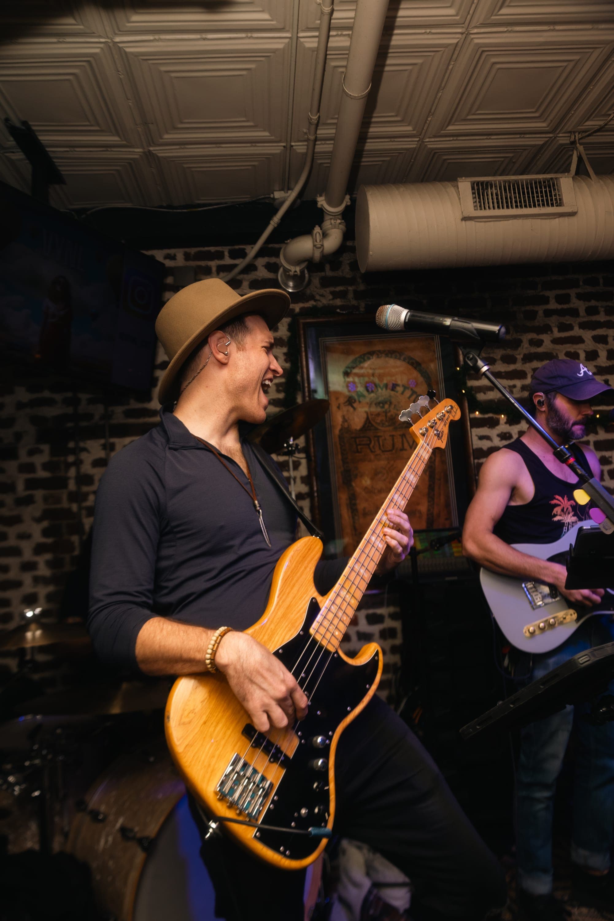 Bassist in a wide-brim hat locking in