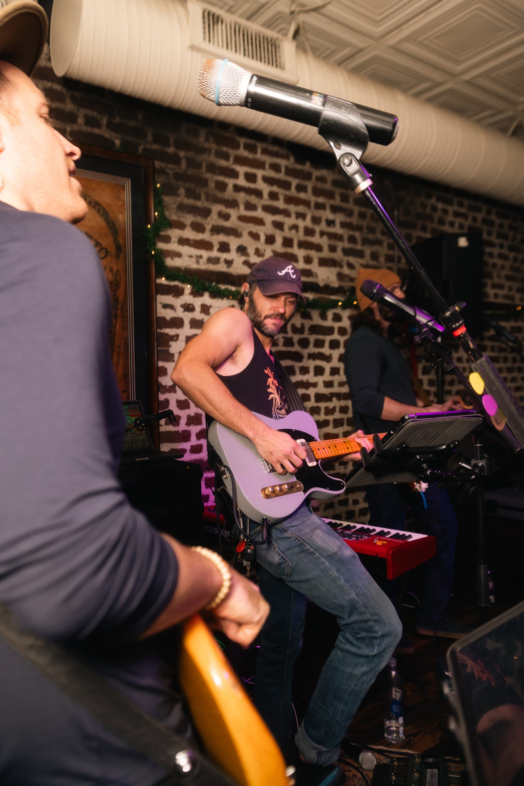 Guitar and keys trading parts against the brick wall