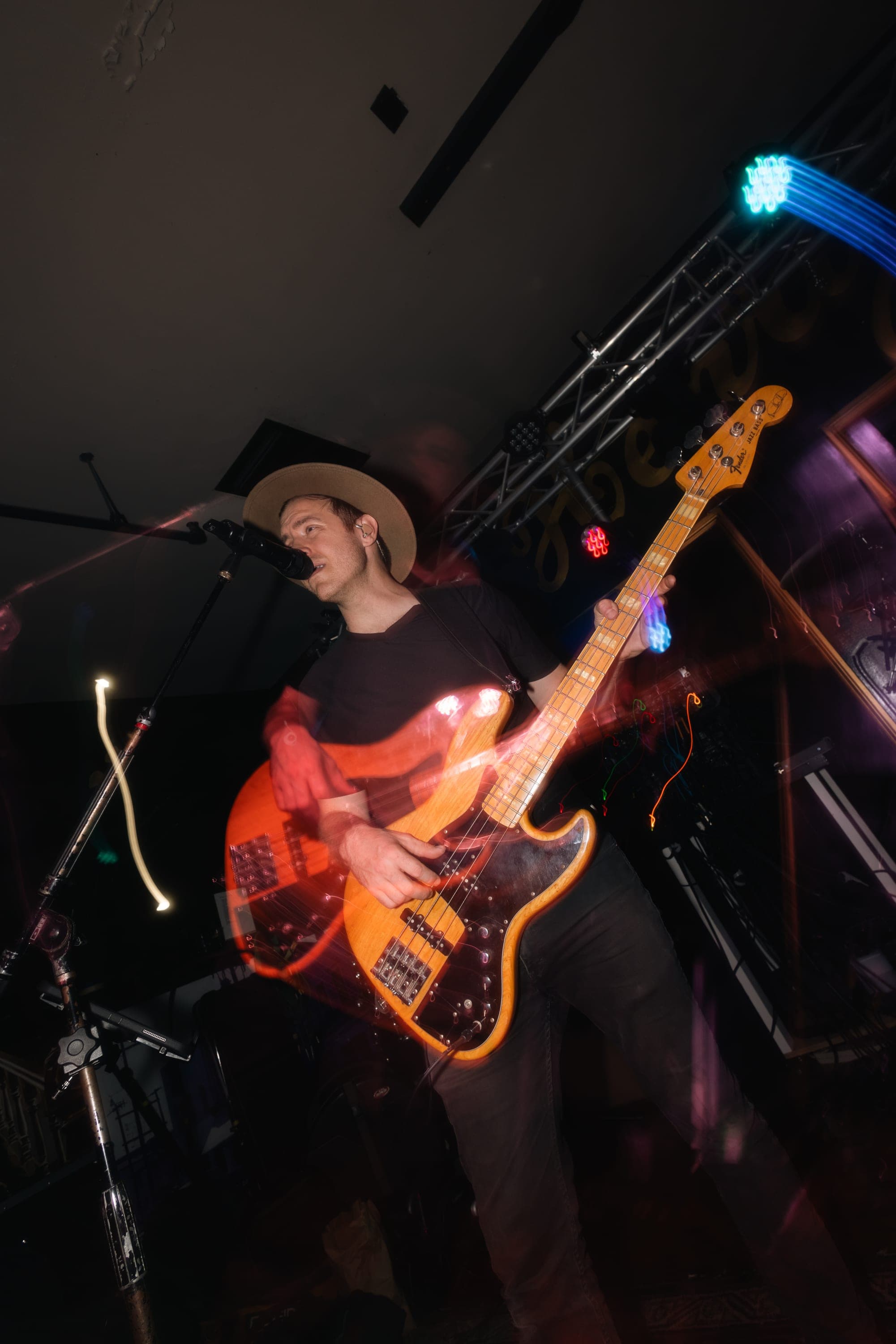 Bassist in motion, lights streaking