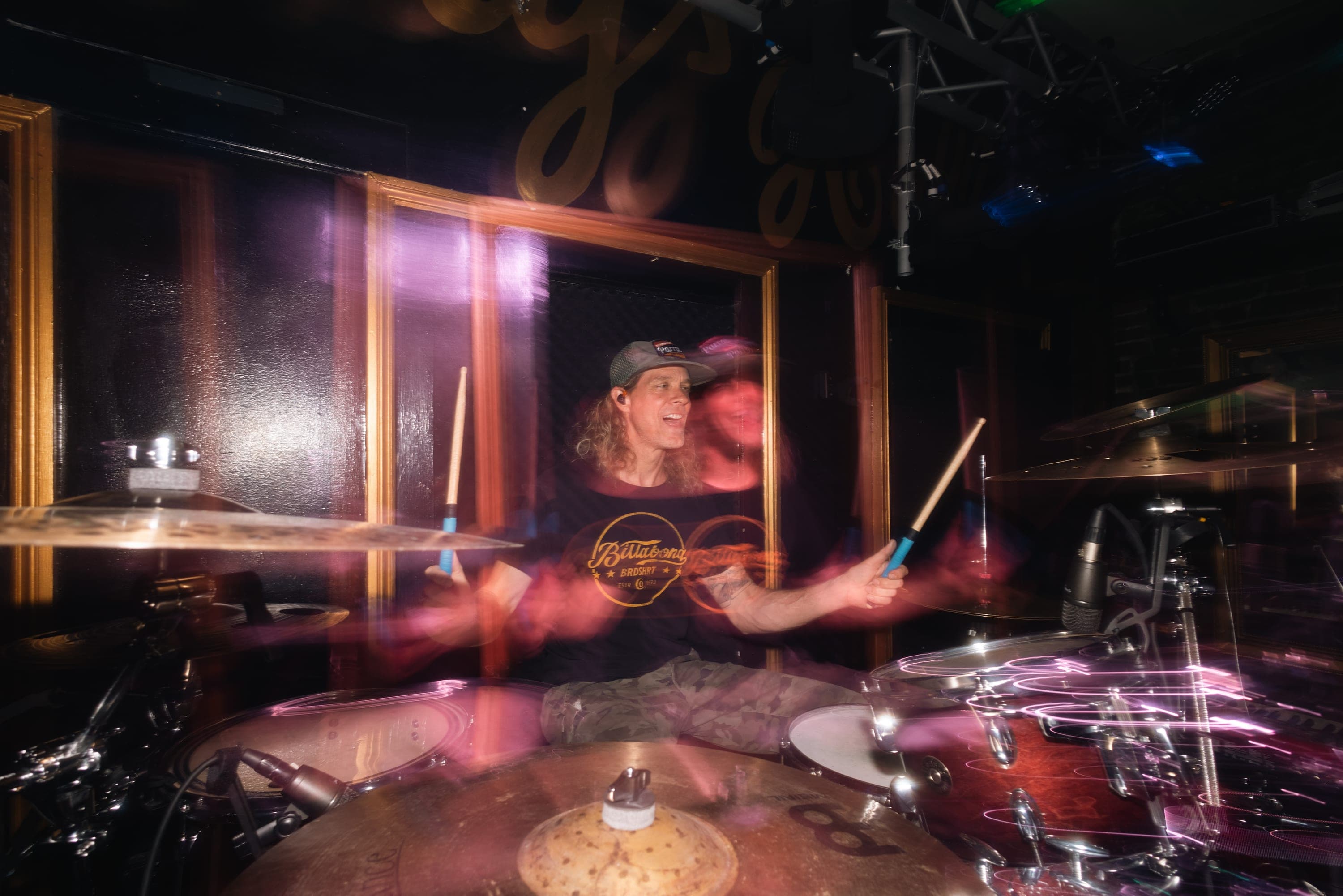 Drummer mid-fill, sticks in motion