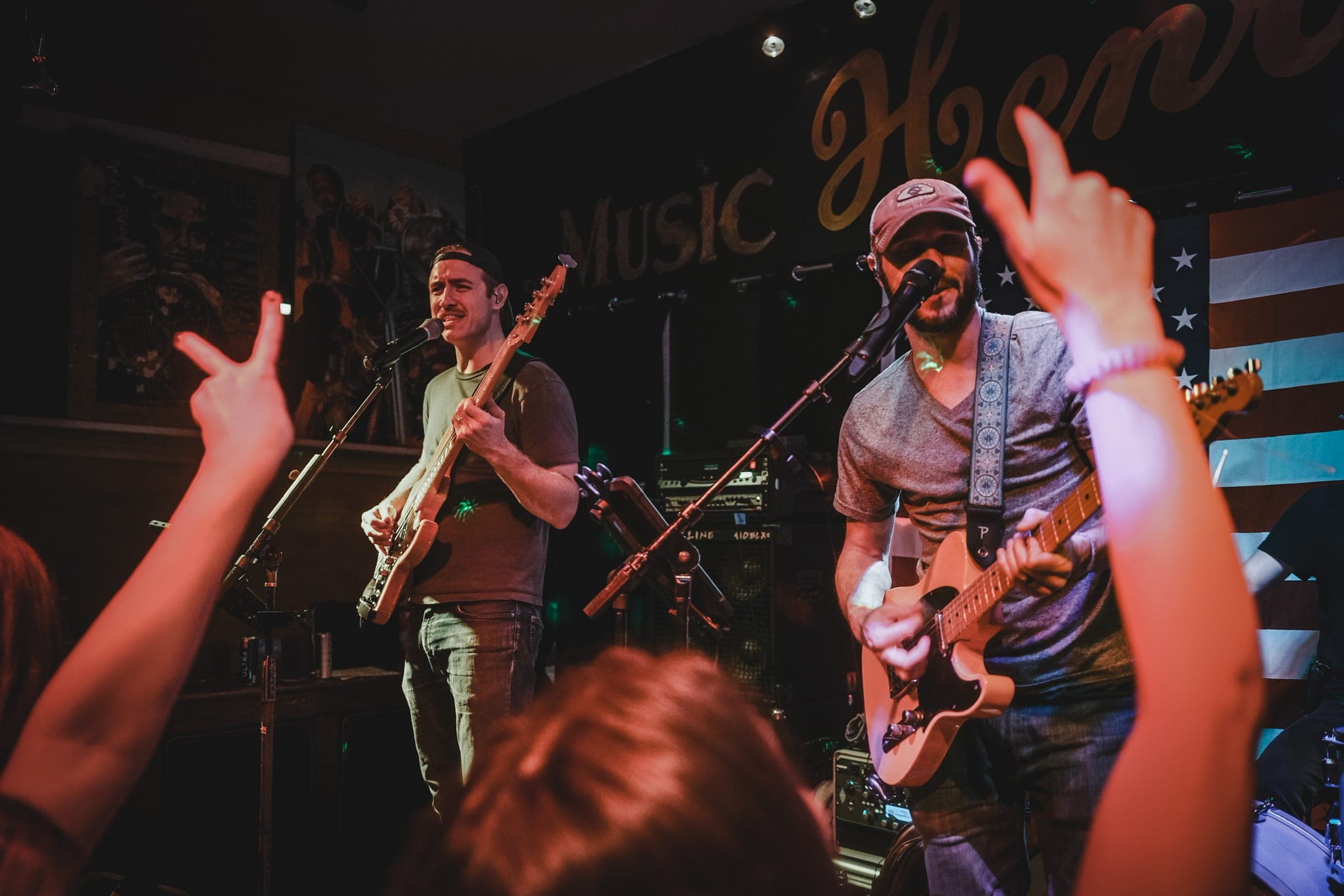 Two singers up front with the crowd’s hands in the air