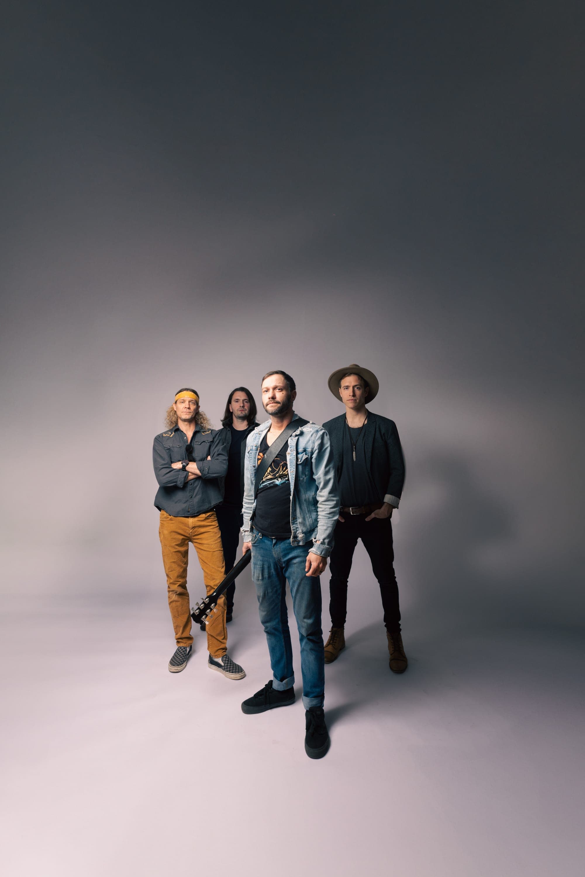 Studio portrait of the four members of VYNL