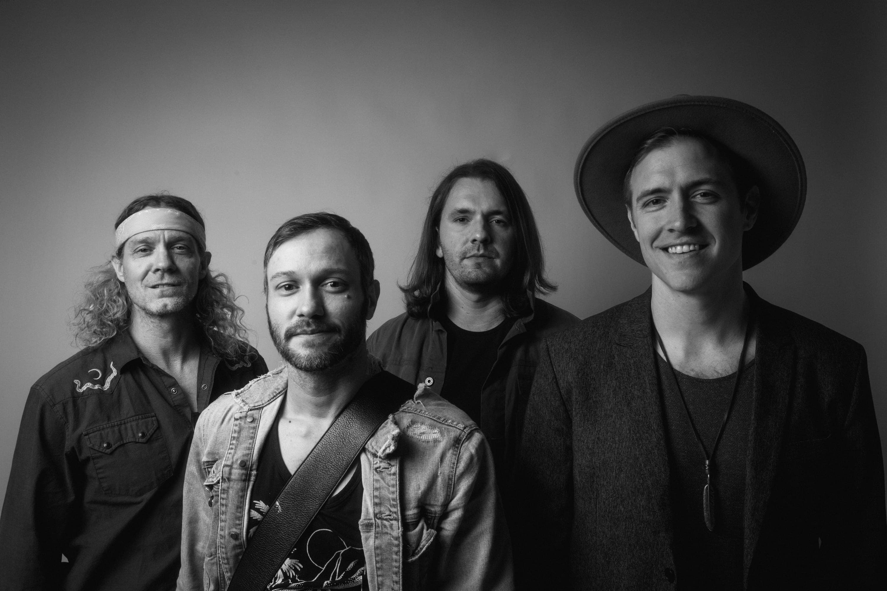 The four members of VYNL, black-and-white portrait